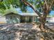 Charming single-story home with mature trees providing shade, well-kept landscaping, and inviting curb appeal at 2727 Waldemere St, Sarasota, FL 34239