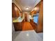 Retro kitchen featuring wood cabinets, a yellow countertop, a white refrigerator, and orange flooring at 2727 Waldemere St, Sarasota, FL 34239