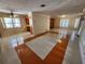 Open-concept living room featuring tile floors, a ceiling fan, and a partial view of the kitchen at 2727 Waldemere St, Sarasota, FL 34239