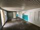 Interior room with green trim, unfinished floors, and a white door at 2727 Waldemere St, Sarasota, FL 34239