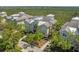 An aerial view of the house shows its location with mature landscaping and nearby water at 275 Sapphire Lake Dr # 101, Bradenton, FL 34209