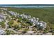 An aerial view displays homes with lush greenery, and water views offering tranquility and scenic landscape at 275 Sapphire Lake Dr # 101, Bradenton, FL 34209