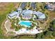 Aerial view of a luxurious community featuring a pool, cabanas, and tropical landscaping at 275 Sapphire Lake Dr # 101, Bradenton, FL 34209