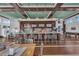 Upscale bar area with mounted TVs, pendant lighting, hardwood floors, and seating at 275 Sapphire Lake Dr # 101, Bradenton, FL 34209