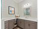 Stylish bathroom with a sink, plenty of storage space, and modern decor with a large vanity mirror at 275 Sapphire Lake Dr # 101, Bradenton, FL 34209