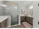 Modern bathroom featuring a glass enclosed shower, double vanity, and shiplap accent wall at 275 Sapphire Lake Dr # 101, Bradenton, FL 34209