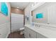Bright bathroom with a large mirror, a white vanity, modern fixtures, and a shower-tub combination at 275 Sapphire Lake Dr # 101, Bradenton, FL 34209