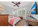 Inviting bedroom featuring natural light, wood floors, plantation shutters, and beach-themed accents at 275 Sapphire Lake Dr # 101, Bradenton, FL 34209