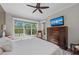 Comfortable bedroom with large window, TV, ceiling fan, dresser, and soft decorative touches at 275 Sapphire Lake Dr # 101, Bradenton, FL 34209