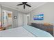 Bright, comfortable bedroom with a ceiling fan and TV mounted above a wooden dresser at 275 Sapphire Lake Dr # 101, Bradenton, FL 34209