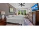 Relaxing bedroom featuring a soft bed, large window with outdoor views, TV and dresser at 275 Sapphire Lake Dr # 101, Bradenton, FL 34209
