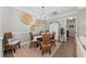 Dining room with wicker chairs, a round table and gray walls with decorative art at 275 Sapphire Lake Dr # 101, Bradenton, FL 34209