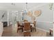 Dining room with light gray walls, wood floors, chandelier and seating for six at 275 Sapphire Lake Dr # 101, Bradenton, FL 34209