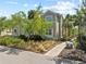 Charming exterior view of a tan two-story townhome with mature landscaping at 275 Sapphire Lake Dr # 101, Bradenton, FL 34209