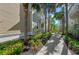 Exterior view of a two-story townhome featuring mature palms and landscaping at 275 Sapphire Lake Dr # 101, Bradenton, FL 34209