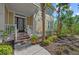 A charming front entrance of a tan two-story townhome with decorative plants at 275 Sapphire Lake Dr # 101, Bradenton, FL 34209