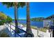 Relaxing hammock strung between palm trees on a sandy beach overlooking the serene waterfront at 275 Sapphire Lake Dr # 101, Bradenton, FL 34209