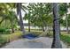 Tranquil hammock nestled between palm trees, offering a serene spot to unwind and enjoy the peaceful waterfront scenery at 275 Sapphire Lake Dr # 101, Bradenton, FL 34209