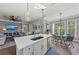 Spacious kitchen with an island, a dining table, and an open floor plan to living area at 275 Sapphire Lake Dr # 101, Bradenton, FL 34209