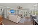 Open-concept living room featuring hardwood floors, a ceiling fan, and sliding glass doors to a porch at 275 Sapphire Lake Dr # 101, Bradenton, FL 34209