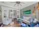 Comfortable living room with white sofa, coastal decor, and access to other rooms through sliding glass doors at 275 Sapphire Lake Dr # 101, Bradenton, FL 34209