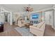 Bright living room with ceiling fan, hardwood floors, sofas, and a decorative console table at 275 Sapphire Lake Dr # 101, Bradenton, FL 34209