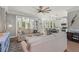 Comfortable living room with a ceiling fan, hardwood floors, and sliding glass doors at 275 Sapphire Lake Dr # 101, Bradenton, FL 34209
