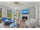 Comfortable living room with fireplace, TV, accent chairs, and windows providing lots of natural light at 275 Sapphire Lake Dr # 101, Bradenton, FL 34209
