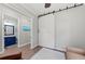 Bright office area with a sliding barn door and a view of a bathroom with a blue vanity at 275 Sapphire Lake Dr # 101, Bradenton, FL 34209