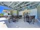 Outdoor kitchen and dining area, perfect for entertaining with a built-in grill and bar seating at 275 Sapphire Lake Dr # 101, Bradenton, FL 34209