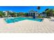 Sparkling community pool with clear blue water, surrounded by a spacious patio and lush landscaping on a sunny day at 275 Sapphire Lake Dr # 101, Bradenton, FL 34209