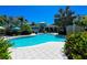 Community pool with a view of the clubhouse, surrounded by lush landscaping and comfortable seating at 275 Sapphire Lake Dr # 101, Bradenton, FL 34209