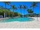 Refreshing community swimming pool with clear water, surrounded by lush landscaping and tile patio at 275 Sapphire Lake Dr # 101, Bradenton, FL 34209