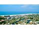 Aerial view of a coastal town with beachfront condos, houses, and winding canals at 2839 Swifton Dr # 28, Sarasota, FL 34231