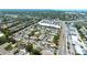 An aerial view showcases the charming condo community with its lush landscaping, a sparkling pool, and nearby commercial area at 2839 Swifton Dr # 28, Sarasota, FL 34231