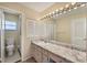 Bathroom with double vanity, large mirrors with vanity lighting and a walk-in shower at 2839 Swifton Dr # 28, Sarasota, FL 34231