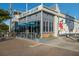 Exterior of The Beach Club, displaying its stylish gray facade, colorful mural, and outdoor patio at 2839 Swifton Dr # 28, Sarasota, FL 34231