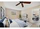 Comfortable bedroom with a ceiling fan, window and a view into an adjacent, well-appointed sitting room at 2839 Swifton Dr # 28, Sarasota, FL 34231