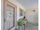 The front door is shown with charming bench seating and greenery at 2839 Swifton Dr # 28, Sarasota, FL 34231
