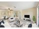 Bright living room with a ceiling fan, neutral walls, and large windows bringing in lots of natural light at 2839 Swifton Dr # 28, Sarasota, FL 34231