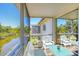 Relaxing screened patio with comfortable seating and a serene view of the lush backyard and tranquil canal at 2839 Swifton Dr # 28, Sarasota, FL 34231