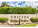 Stone sign surrounded by shrubbery marks Swifton, a 55+ age-restricted community at 2839 Swifton Dr # 28, Sarasota, FL 34231