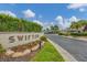 Community sign for Swifton, surrounded by lovely landscaping with a view of the homes at 2839 Swifton Dr # 28, Sarasota, FL 34231
