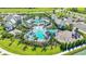 Beautiful aerial shot of a community pool, clubhouse, playground, and lush landscaping at 2918 Butterfly Jasmine Trl, Sarasota, FL 34240