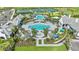 Aerial view of community amenities including swimming pools, tennis courts, and lush landscaping at 2918 Butterfly Jasmine Trl, Sarasota, FL 34240