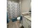 Bathroom featuring blue and gray patterned shower curtain, white vanity and blue bath mat at 2918 Butterfly Jasmine Trl, Sarasota, FL 34240