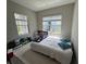 Bright bedroom with neutral walls, carpeted floors, and a white bed at 2918 Butterfly Jasmine Trl, Sarasota, FL 34240