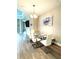 Dining area features a glass table and white chairs at 2918 Butterfly Jasmine Trl, Sarasota, FL 34240