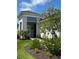 Attractive home exterior with manicured landscaping, a paved walkway, and a stylish blue accent at 2918 Butterfly Jasmine Trl, Sarasota, FL 34240
