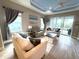 Cozy living room featuring comfortable seating, ceiling fan, and sliding doors to the lanai at 2918 Butterfly Jasmine Trl, Sarasota, FL 34240